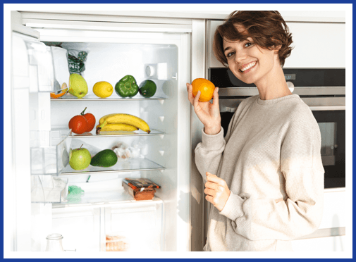 Homeowner at an open refrigerator full of fresh food