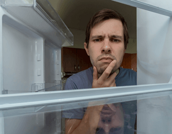Homeowner looking into an empty refrigerator