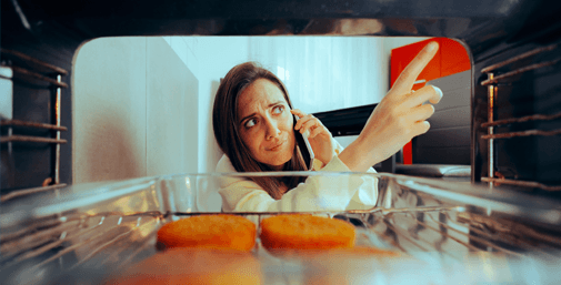 Homeowner checking food inside an oven