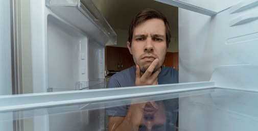Homeowner looking into an empty refrigerator