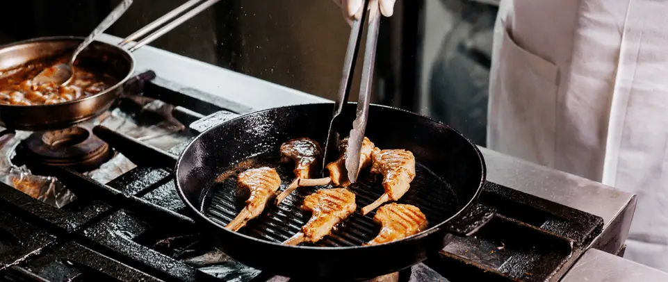 Chef cooking on a commercial grill